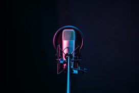 Studio microphone and pop shield on mic in the empty recording studio with copy space. Performance and show in the music business equipment.